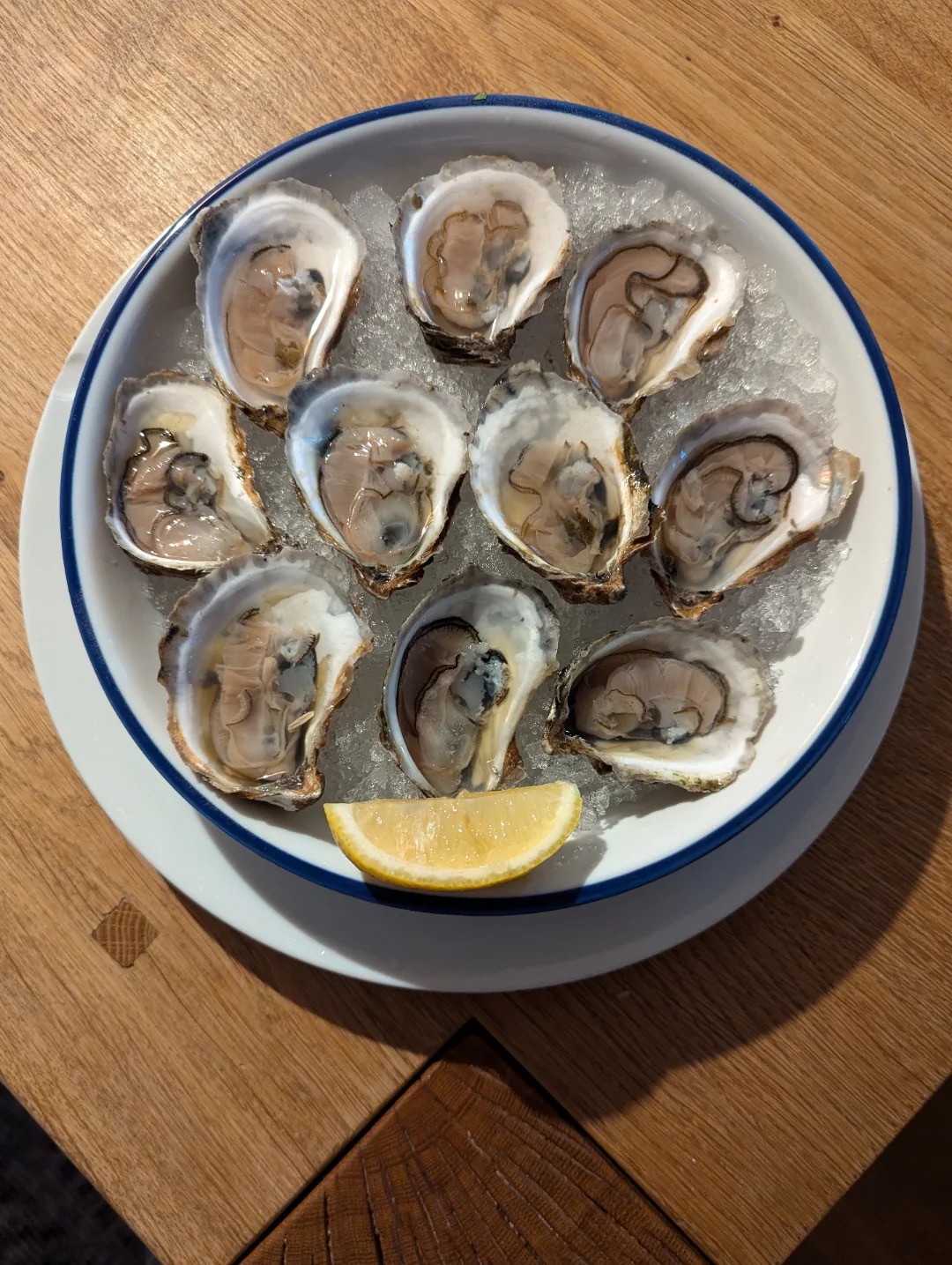 Freshly shucked oysters on ice with a wedge of lemon at Whiskey & Water
