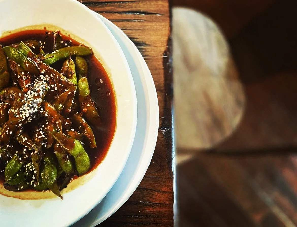 Charred green vegetables in a dark soy glaze finished with sesame at Whiskey & Water, Blue Ridge, Georgia