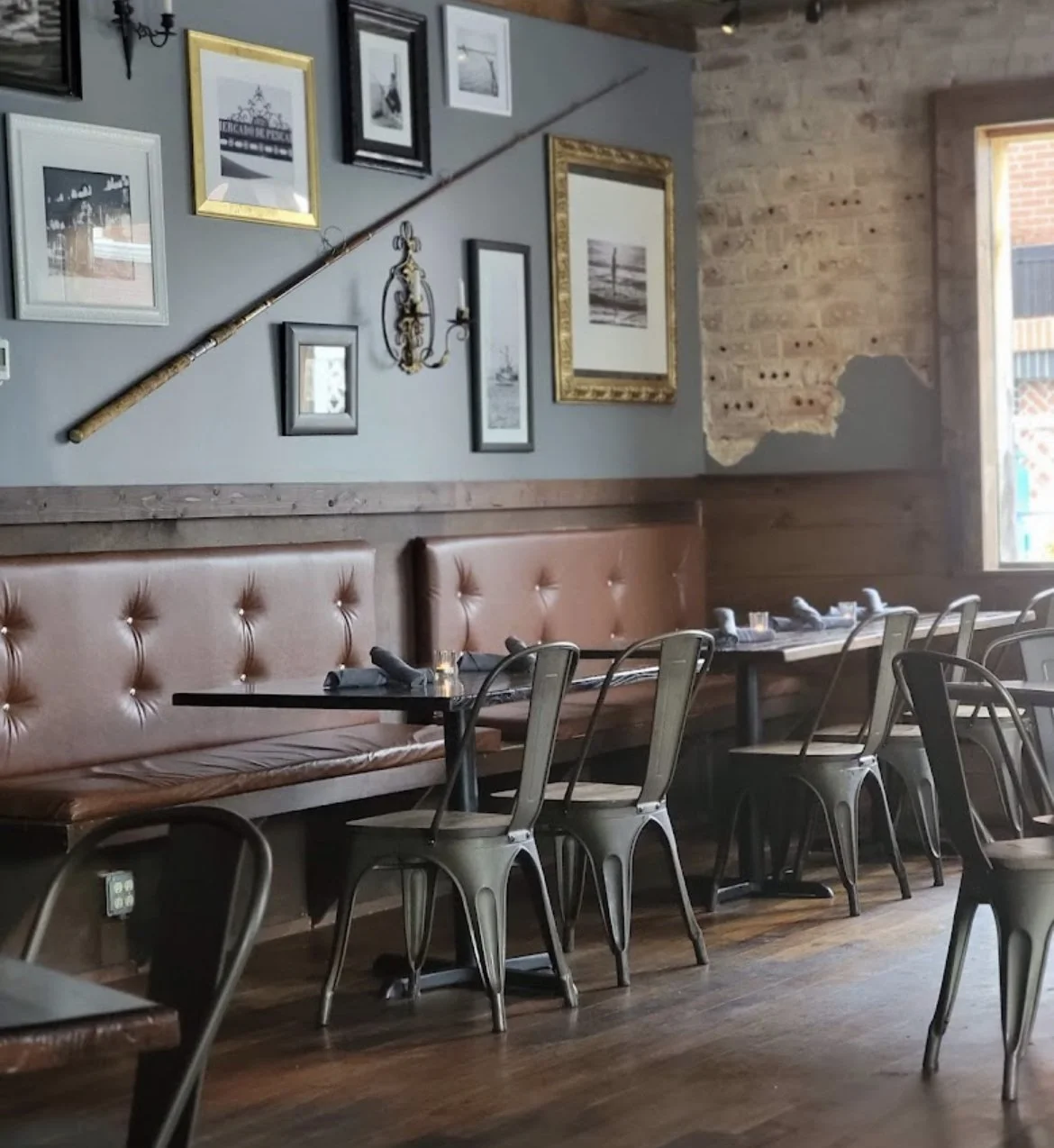 Tufted leather banquettes and wood tables beside the exposed brick of the historic Blue Ridge post office building