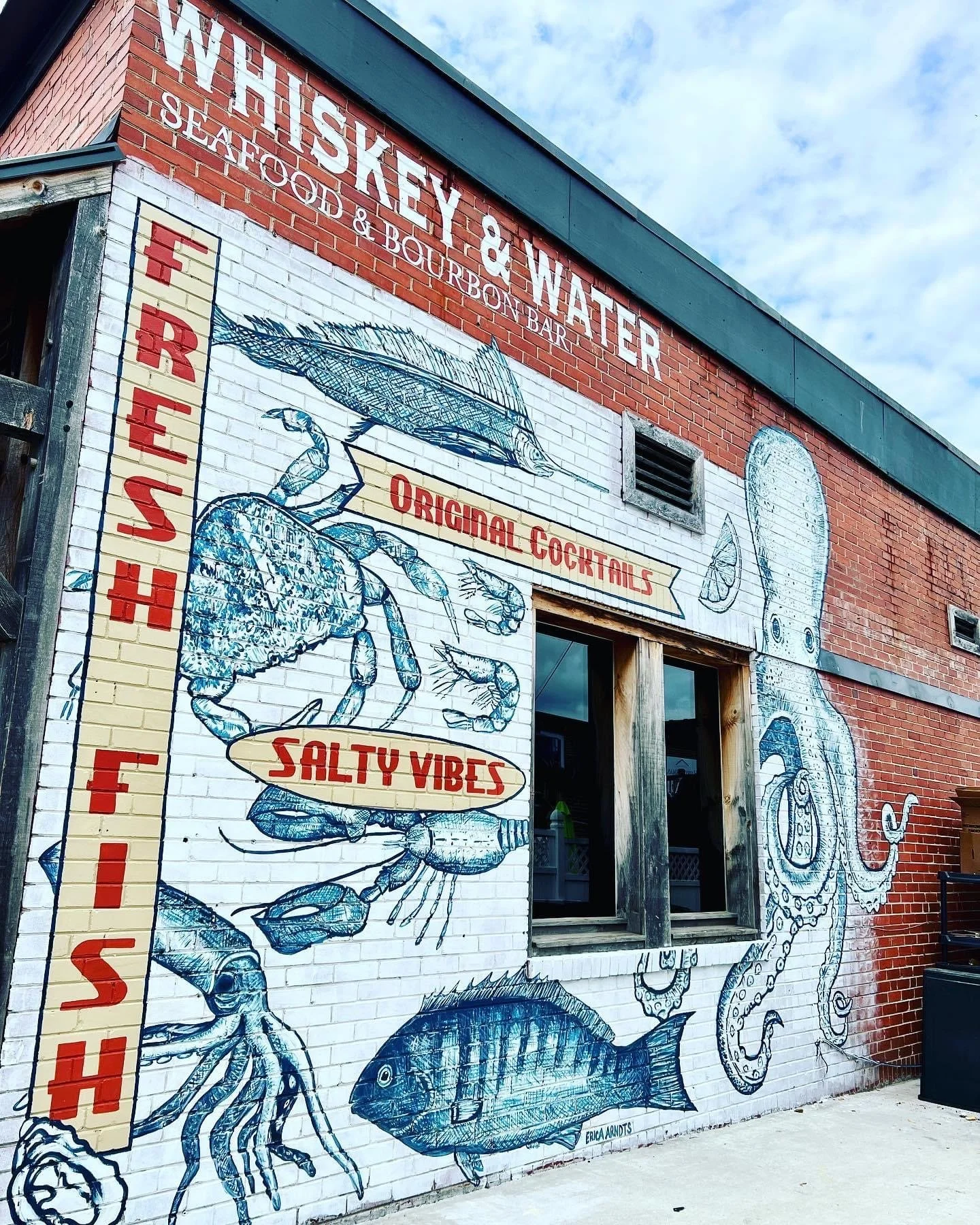 The hand-painted crab, fish and octopus mural on the restored 1937 historic post office that houses Whiskey & Water in downtown Blue Ridge, Georgia